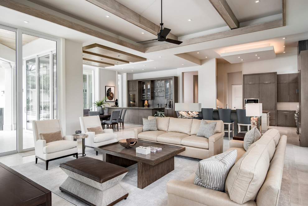 Photo of a large transitional open concept family room in Miami with white walls and travertine floors.