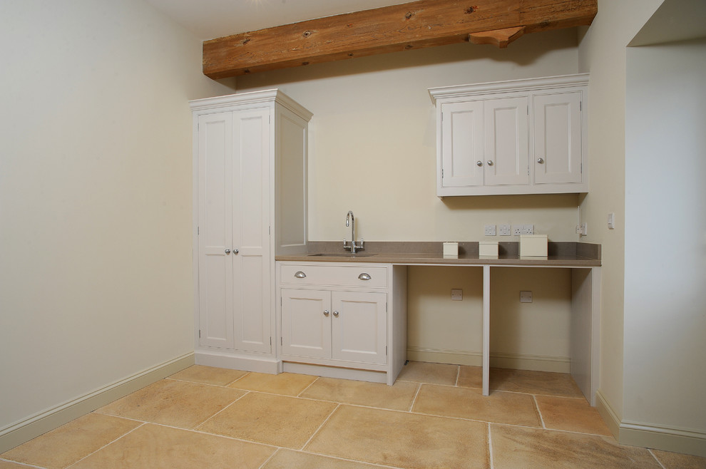 Design ideas for a traditional laundry room in Gloucestershire with a single-bowl sink, quartzite benchtops, limestone floors and a side-by-side washer and dryer.