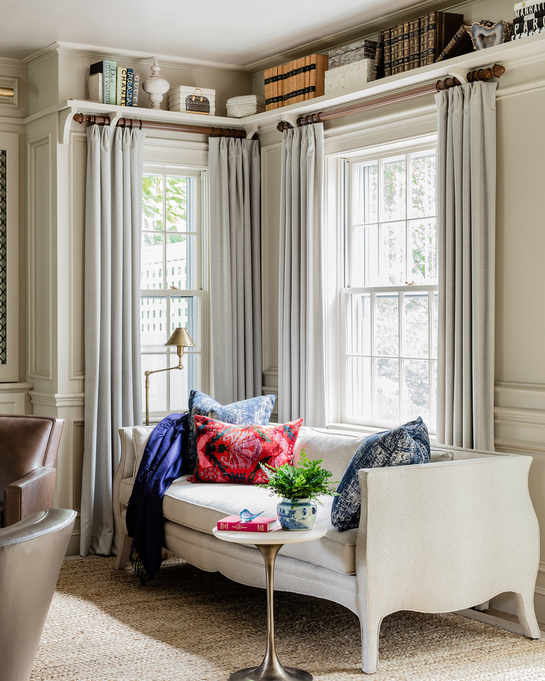 This is an example of a traditional family room in Boston with a library and beige walls.