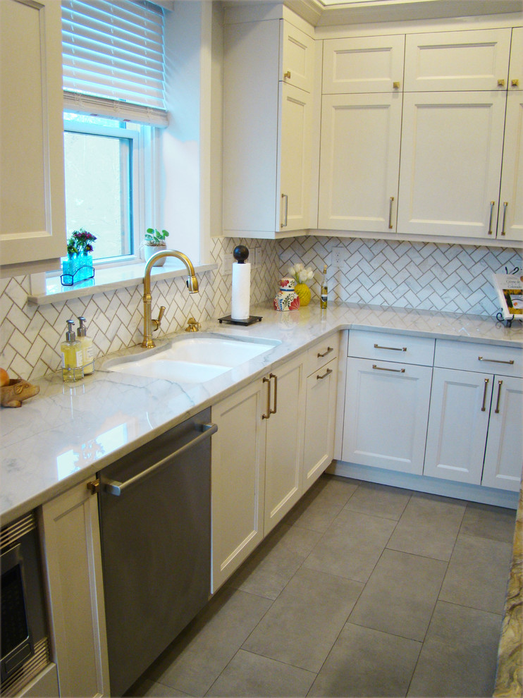 Example of a large transitional u-shaped ceramic tile and gray floor eat-in kitchen design in Denver with a double-bowl sink, recessed-panel cabinets, white cabinets, granite countertops, white backsplash, marble backsplash, stainless steel appliances, an island and multicolored countertops