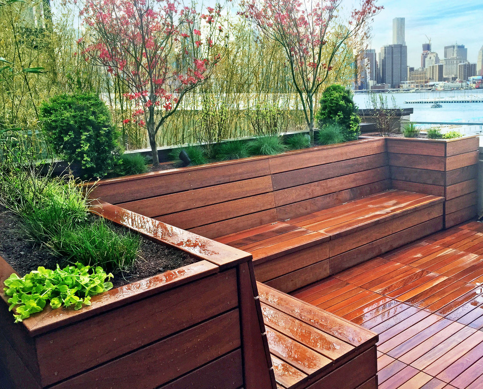 This is an example of a contemporary rooftop deck in New York with a container garden.