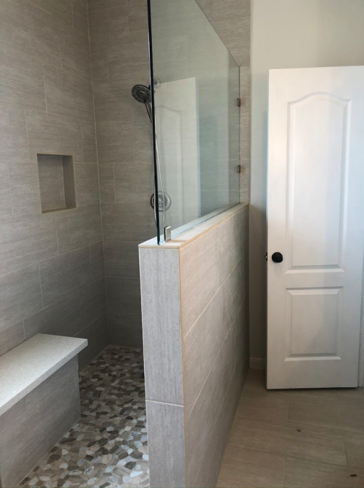This is an example of a medium sized modern ensuite bathroom in Houston with shaker cabinets, beige cabinets, a one-piece toilet, beige tiles, ceramic tiles, grey walls, ceramic flooring, a vessel sink, engineered stone worktops, beige floors, white worktops, a built in vanity unit and a single sink.