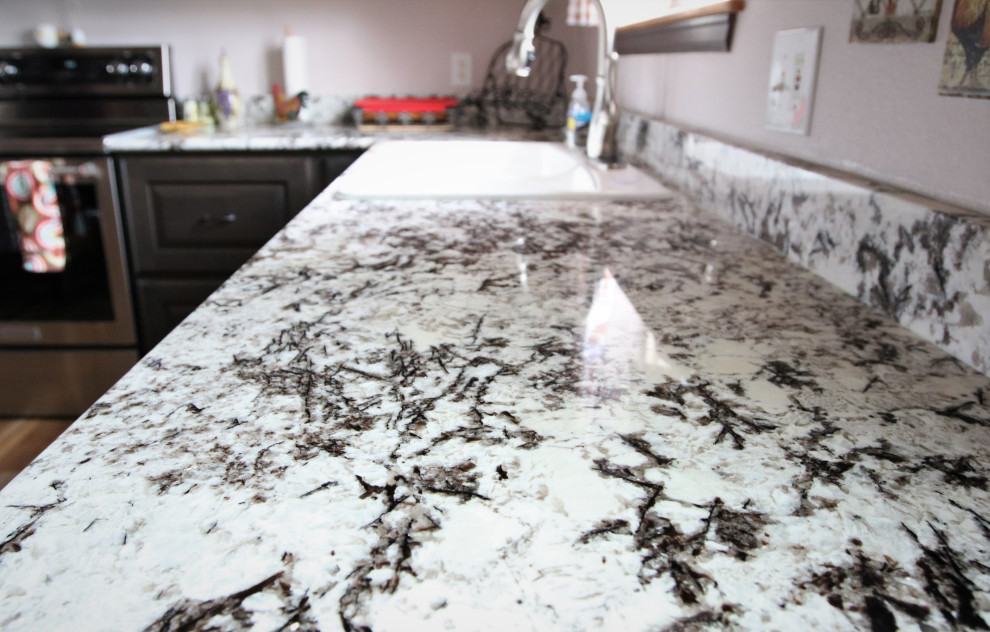 Example of a large l-shaped eat-in kitchen design with a drop-in sink, gray cabinets, granite countertops, no island and multicolored countertops