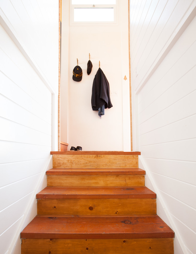 This is an example of a small scandinavian wood straight staircase in San Francisco with wood risers.