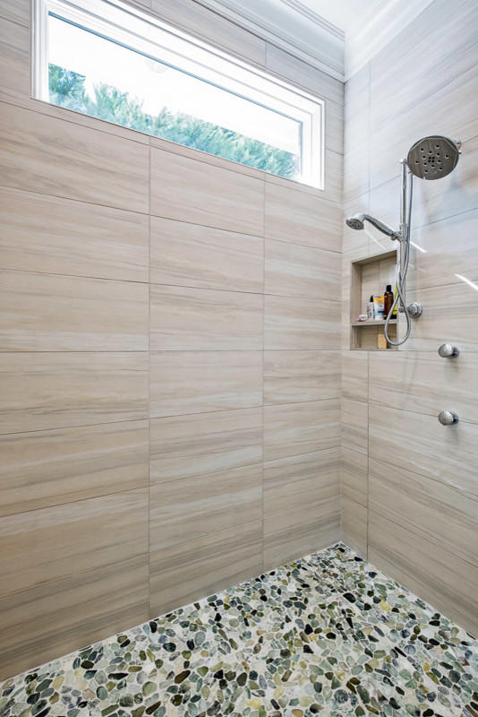 This is an example of a large transitional master bathroom in Other with recessed-panel cabinets, white cabinets, a curbless shower, beige walls, porcelain floors, an undermount sink, granite benchtops, beige floor, an open shower and grey benchtops.