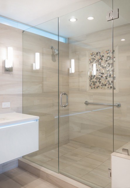 Photo of a mid-sized master bathroom in Miami with flat-panel cabinets, white cabinets, a corner shower, beige tile, travertine, white walls, travertine floors, an undermount sink, laminate benchtops, beige floor and a hinged shower door.