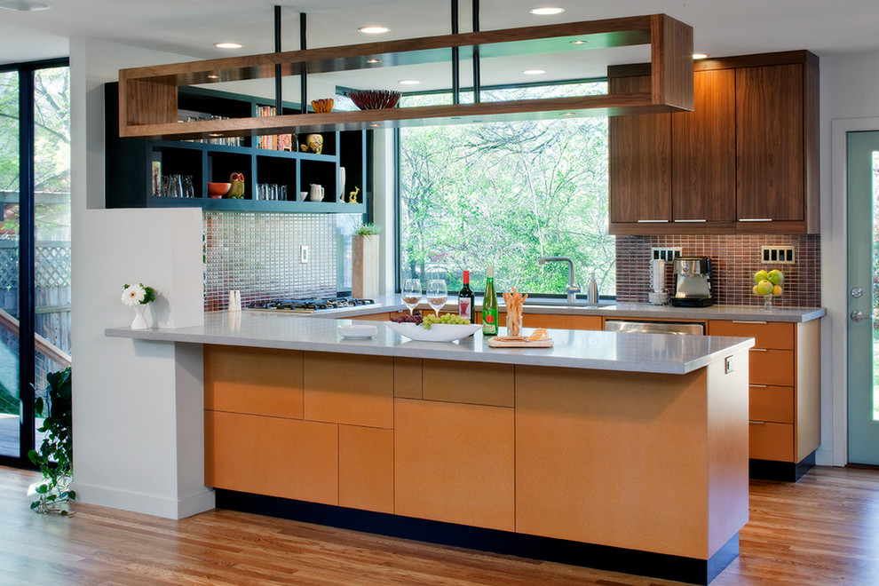 Photo of a contemporary u-shaped kitchen in Austin with an undermount sink, flat-panel cabinets, medium wood cabinets, brown splashback, mosaic tile splashback and stainless steel appliances.
