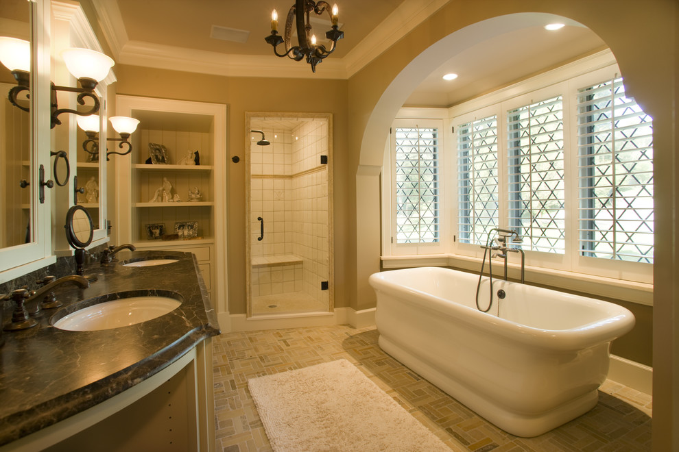 Traditional bathroom in Minneapolis with a freestanding tub and marble benchtops.