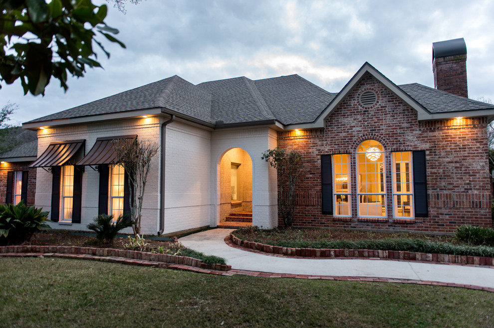 Photo of a large contemporary one-storey brick beige exterior in New Orleans.