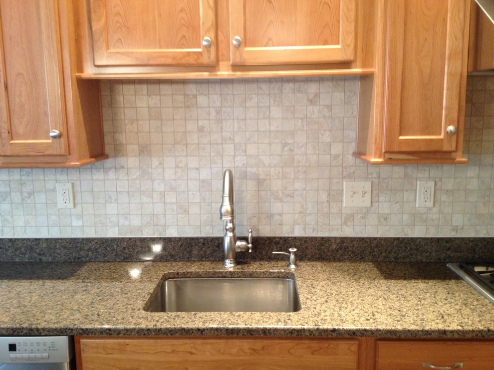 Example of a transitional l-shaped vinyl floor eat-in kitchen design in Boston with a single-bowl sink, recessed-panel cabinets, granite countertops, beige backsplash, stone tile backsplash and no island
