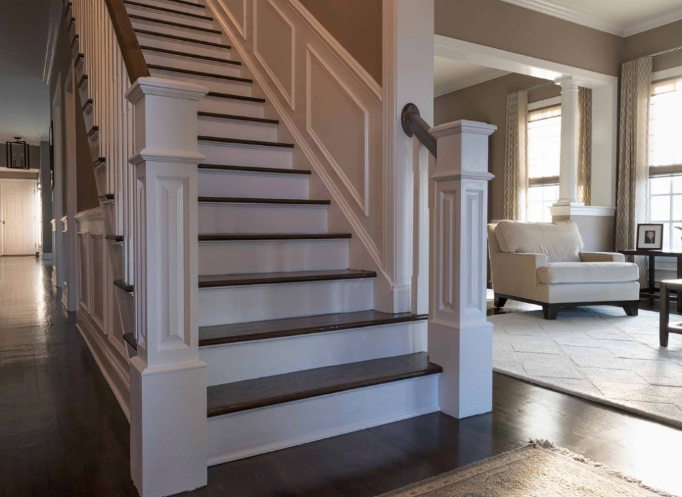 Inspiration for a mid-sized transitional wood straight staircase in New York with painted wood risers and wood railing.