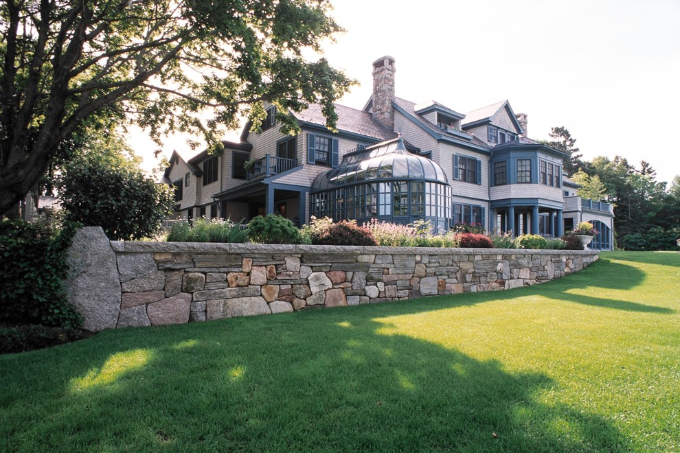 Inspiration for a large rustic partial sun backyard retaining wall landscape.