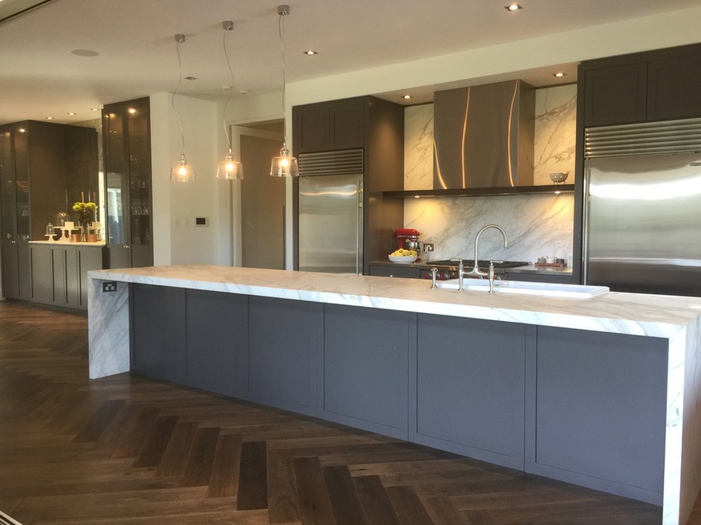 This is an example of a mid-sized contemporary single-wall kitchen in Adelaide with shaker cabinets, a farmhouse sink, black cabinets, marble benchtops, marble splashback, stainless steel appliances and dark hardwood floors.