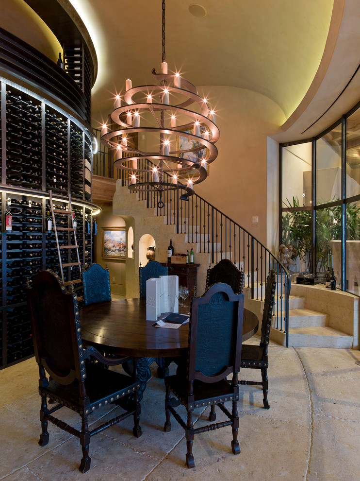 This is an example of a mediterranean wine cellar in Austin with concrete floors.