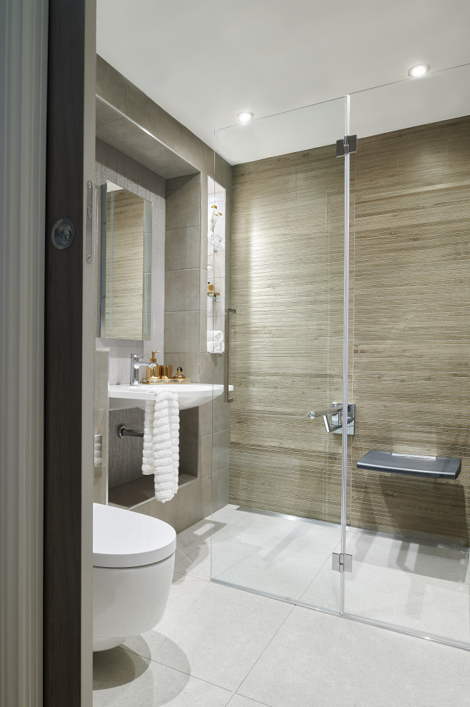 This is an example of a mid-sized contemporary 3/4 bathroom in London with an open shower, a wall-mount toilet, porcelain tile, porcelain floors, a wall-mount sink, white floor, a hinged shower door and gray tile.