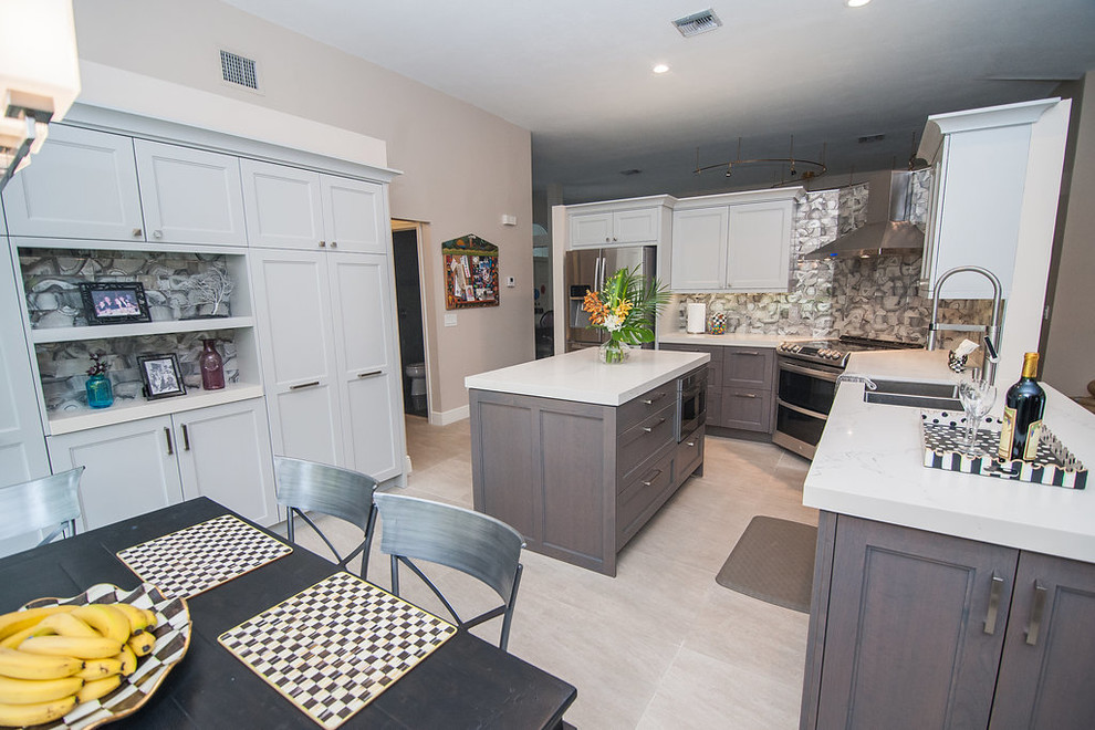 Example of a mid-sized transitional u-shaped porcelain tile and beige floor eat-in kitchen design in Miami with an undermount sink, shaker cabinets, gray cabinets, quartz countertops, gray backsplash, glass tile backsplash, stainless steel appliances, an island and white countertops