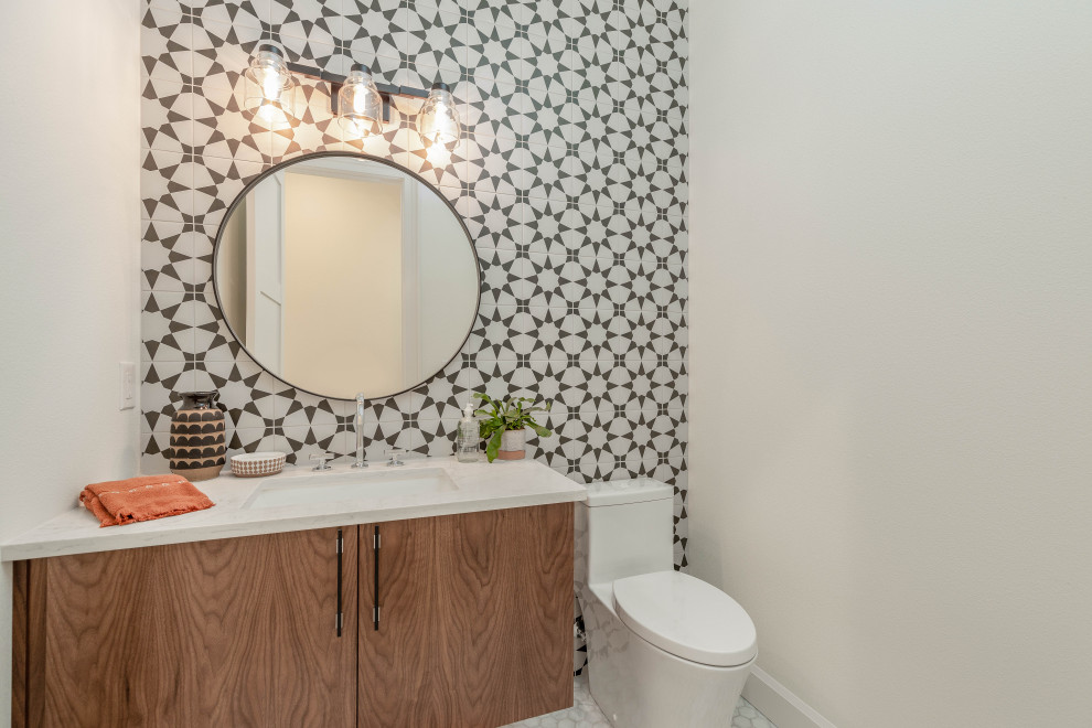 Photo of a medium sized cloakroom in Portland with flat-panel cabinets, medium wood cabinets, a one-piece toilet, multi-coloured tiles, ceramic tiles, white walls, porcelain flooring, a submerged sink, quartz worktops, white floors, white worktops and a floating vanity unit.
