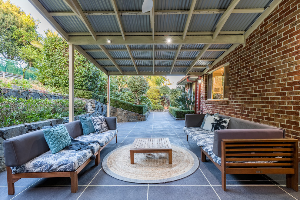 This is an example of a large transitional patio in Other with concrete slab and a pergola.
