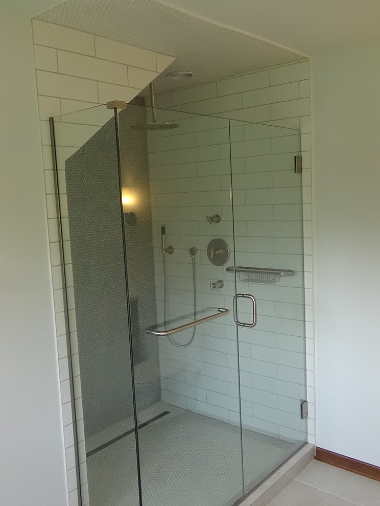 Inspiration for a mid-sized transitional master white tile and ceramic tile porcelain tile and beige floor freestanding bathtub remodel in Chicago with recessed-panel cabinets, medium tone wood cabinets, a wall-mount toilet, white walls, an undermount sink, quartz countertops, a hinged shower door and white countertops