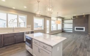 Example of a mid-sized transitional l-shaped medium tone wood floor open concept kitchen design with an undermount sink, shaker cabinets, dark wood cabinets, marble countertops, white backsplash, subway tile backsplash, stainless steel appliances and an island