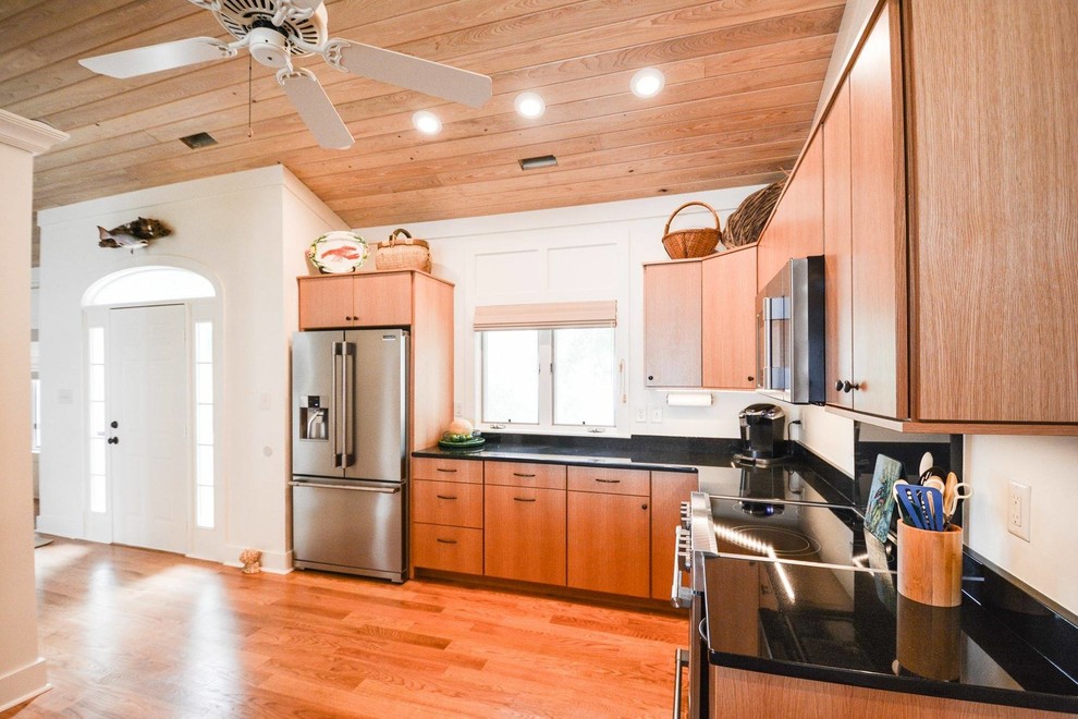 Mid-sized transitional l-shaped medium tone wood floor and brown floor open concept kitchen photo with flat-panel cabinets, medium tone wood cabinets, quartz countertops, stainless steel appliances and no island
