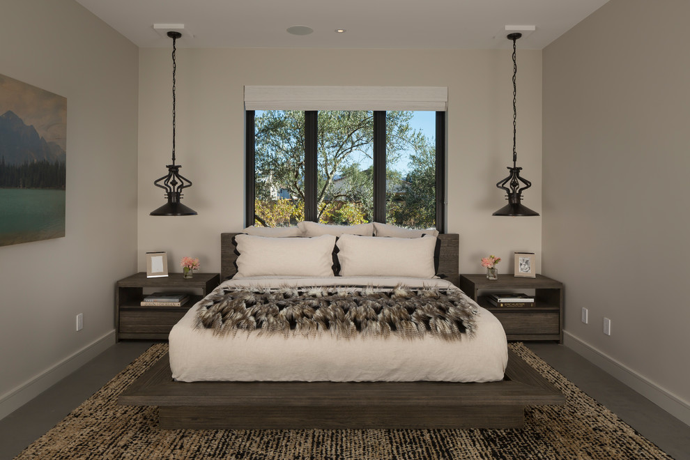 This is an example of an expansive contemporary guest bedroom in San Francisco with white walls, no fireplace, concrete floors and grey floor.