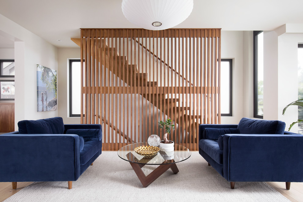 Inspiration for a mid-sized midcentury wood floating staircase in Calgary with open risers and wood railing.