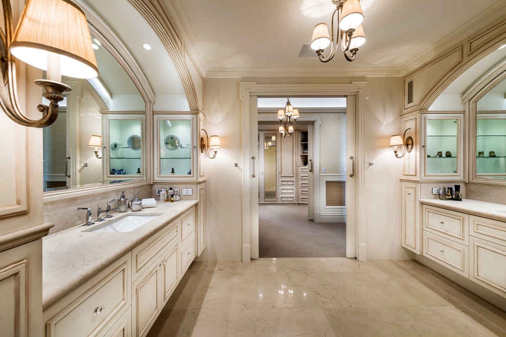 Inspiration for a large traditional master bathroom in Perth with recessed-panel cabinets, distressed cabinets, a double shower, beige tile, stone tile, beige walls, an undermount sink, marble benchtops and marble floors.