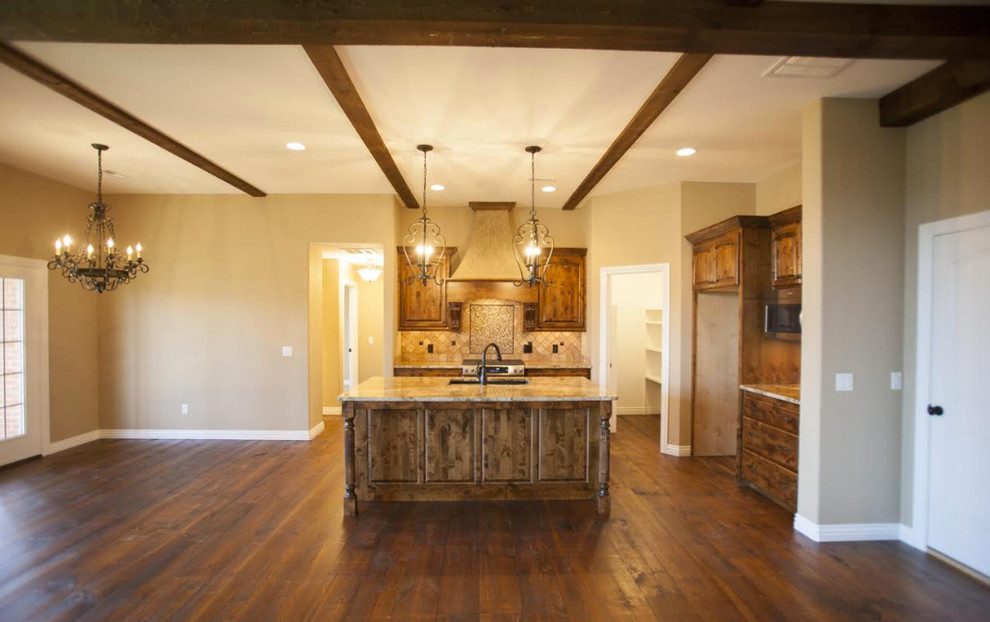 Inspiration for a mid-sized rustic l-shaped dark wood floor and brown floor open concept kitchen remodel with an undermount sink, raised-panel cabinets, medium tone wood cabinets, granite countertops, beige backsplash, ceramic backsplash, stainless steel appliances and an island