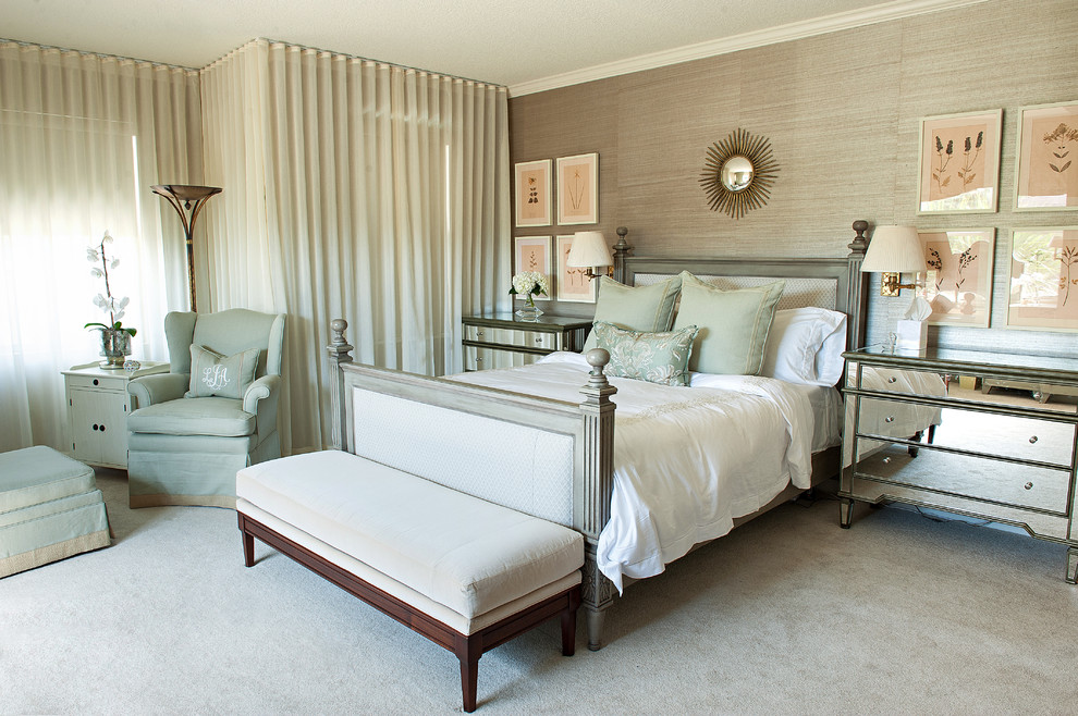 This is an example of a traditional bedroom in Jacksonville with beige walls and carpet.