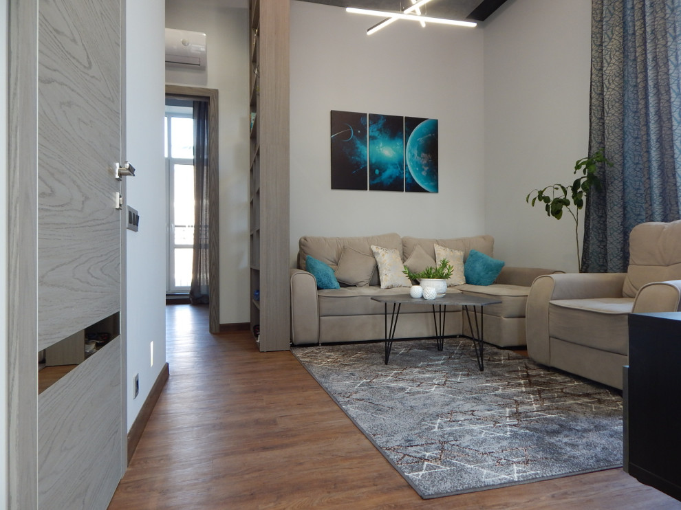 This is an example of a medium sized contemporary open plan living room feature wall in Moscow with a music area, multi-coloured walls, laminate floors, a wall mounted tv, brown floors, a drop ceiling and panelled walls.