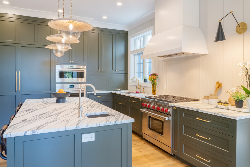 Mid-sized transitional l-shaped light wood floor and brown floor eat-in kitchen photo in New York with a single-bowl sink, shaker cabinets, gray cabinets, marble countertops, white backsplash, shiplap backsplash, stainless steel appliances, an island and multicolored countertops