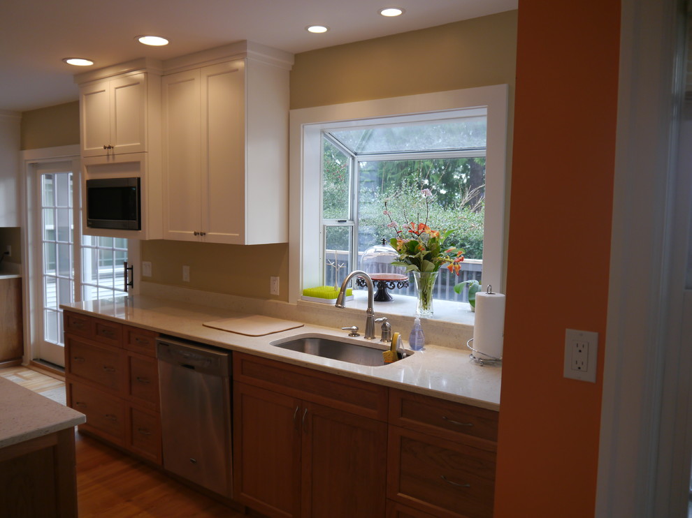 Transitional kitchen photo in Seattle with an undermount sink, shaker cabinets, quartzite countertops, stainless steel appliances and an island