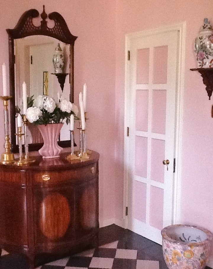 Front door - small ceramic tile front door idea with pink walls