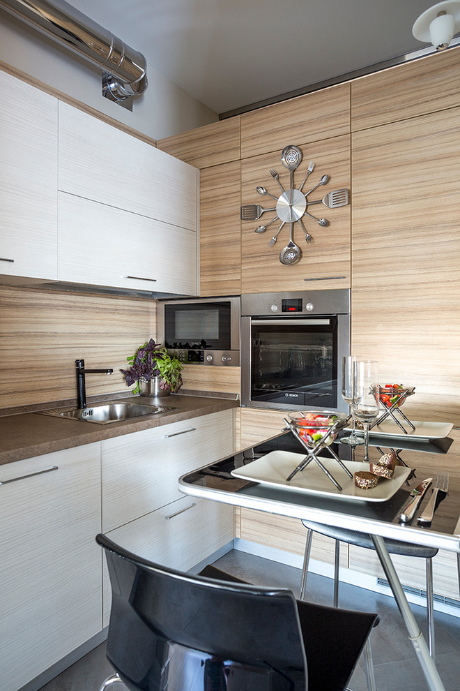Inspiration for a small contemporary l-shaped separate kitchen in Moscow with a drop-in sink, laminate benchtops, stainless steel appliances, porcelain floors, flat-panel cabinets, white cabinets, brown splashback and no island.