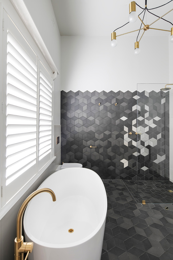 This is an example of a contemporary master bathroom in Adelaide with dark wood cabinets, a freestanding tub, an open shower, multi-coloured tile, cement tile, grey walls and an open shower.