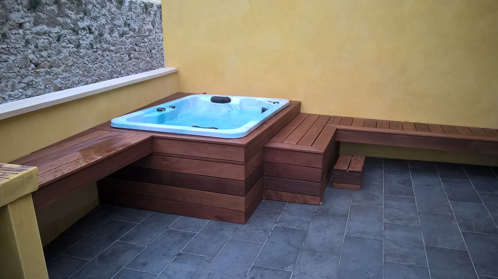 Small traditional courtyard custom-shaped aboveground pool in Montpellier with a hot tub.