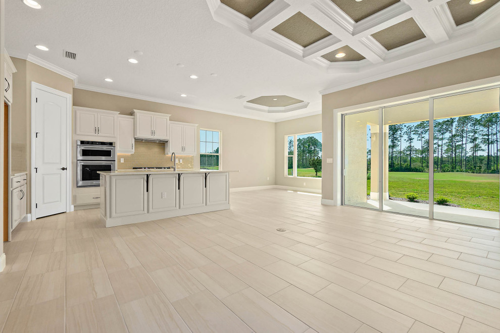 Photo of a large traditional open concept living room in Orlando with beige walls, beige floor, coffered and ceramic floors.