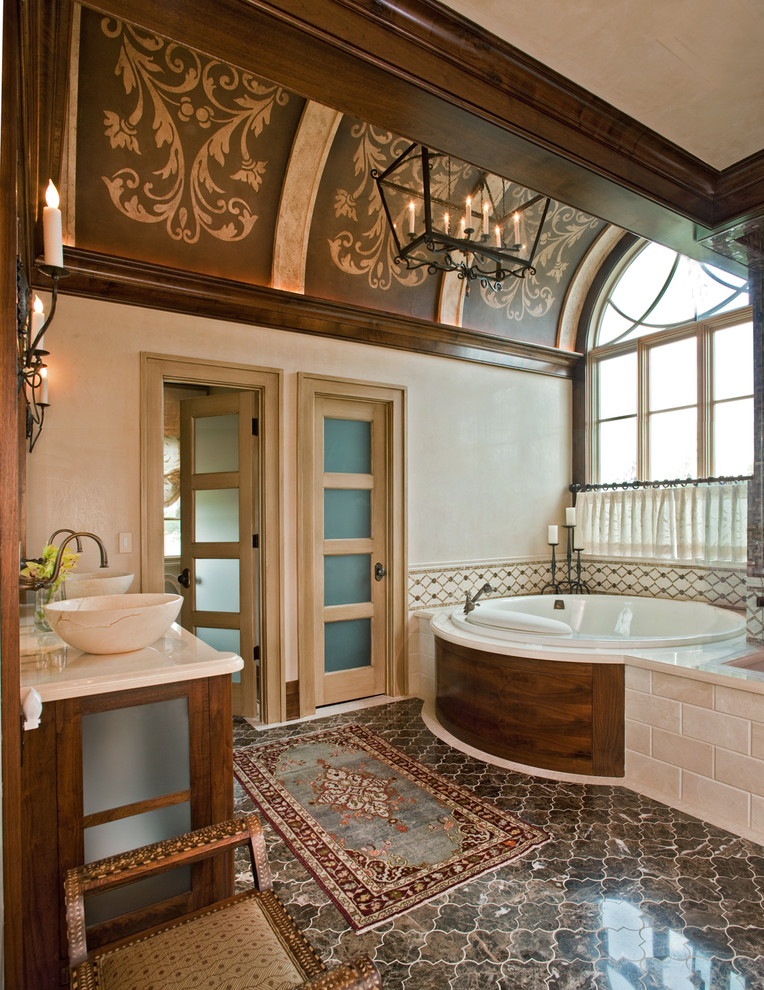 Inspiration for a traditional bathroom in Dallas with a vessel sink, a drop-in tub and beige tile.