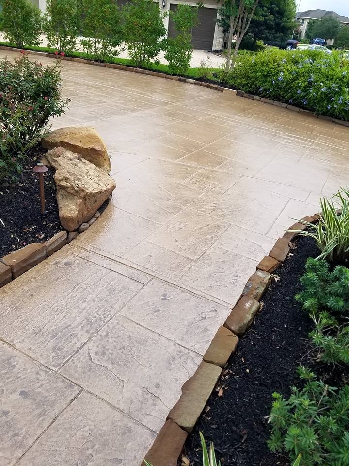 Design ideas for a mid-sized traditional driveway in Houston with a garden path and concrete pavers.