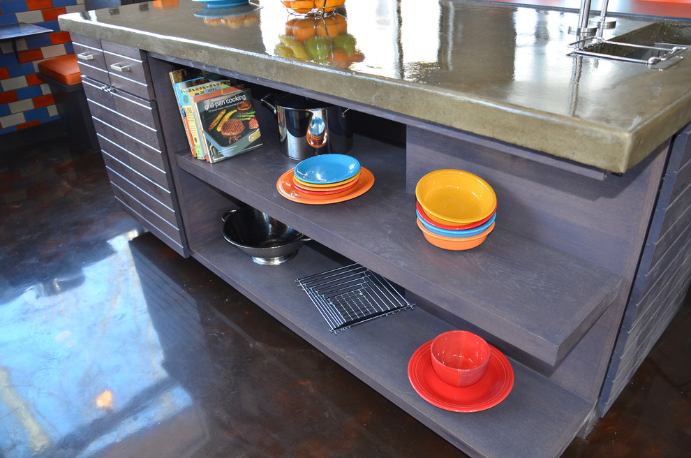 Eat-in kitchen - large contemporary l-shaped eat-in kitchen idea with louvered cabinets, gray cabinets, concrete countertops, orange backsplash, ceramic backsplash, stainless steel appliances and an island