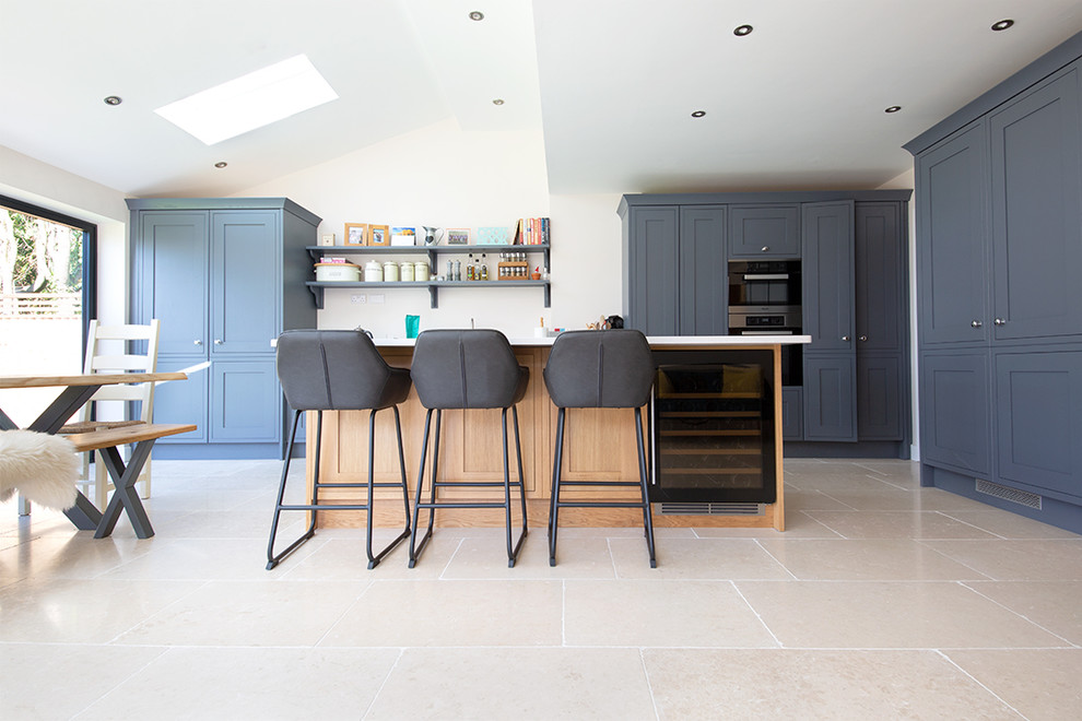 Photo of a contemporary kitchen in Other with limestone floors and with island.