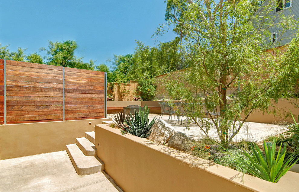 Inspiration for a mid-sized mediterranean backyard full sun garden in San Diego with a retaining wall.