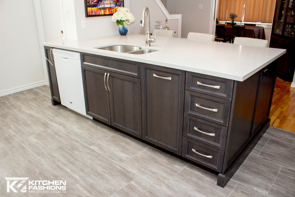 Inspiration for a mid-sized transitional single-wall ceramic tile open concept kitchen remodel with an undermount sink, shaker cabinets, gray cabinets, solid surface countertops, gray backsplash, mosaic tile backsplash, white appliances and an island