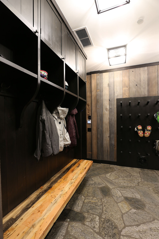 Large mountain style gray floor mudroom photo with a dark wood front door