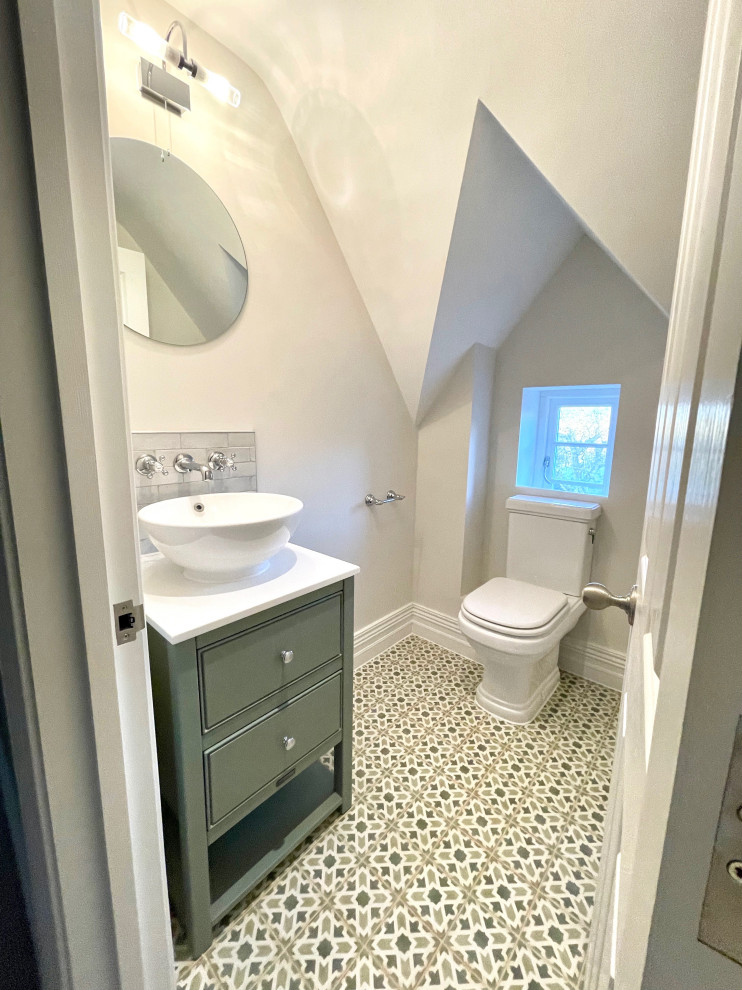 Inspiration for a small traditional bathroom in Hertfordshire with green cabinets, a single vanity and a freestanding vanity.