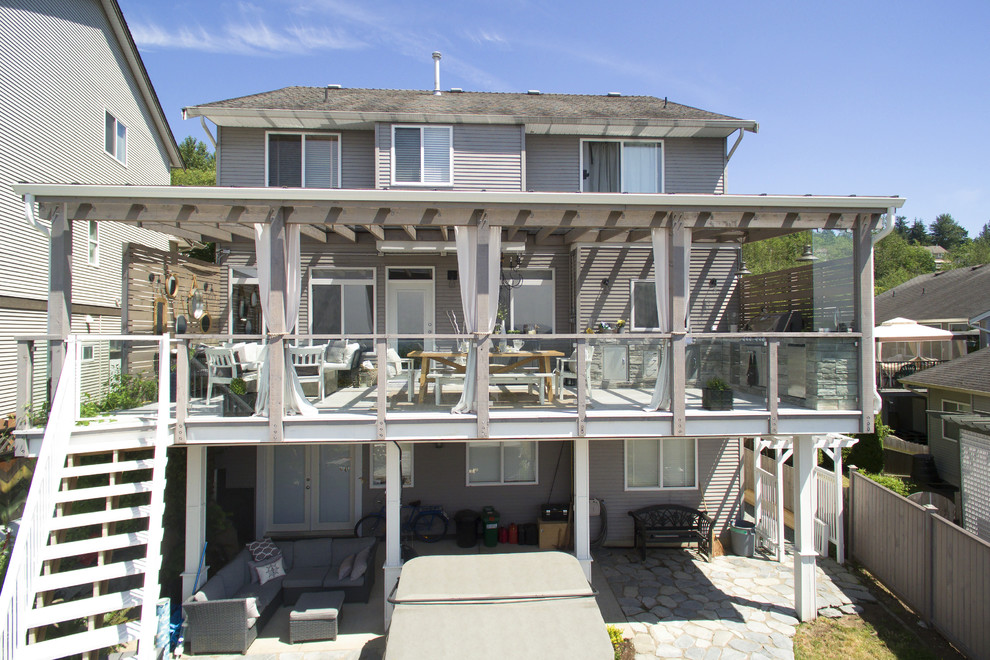 Inspiration for a large transitional backyard outdoor kitchen deck remodel in Vancouver with a pergola
