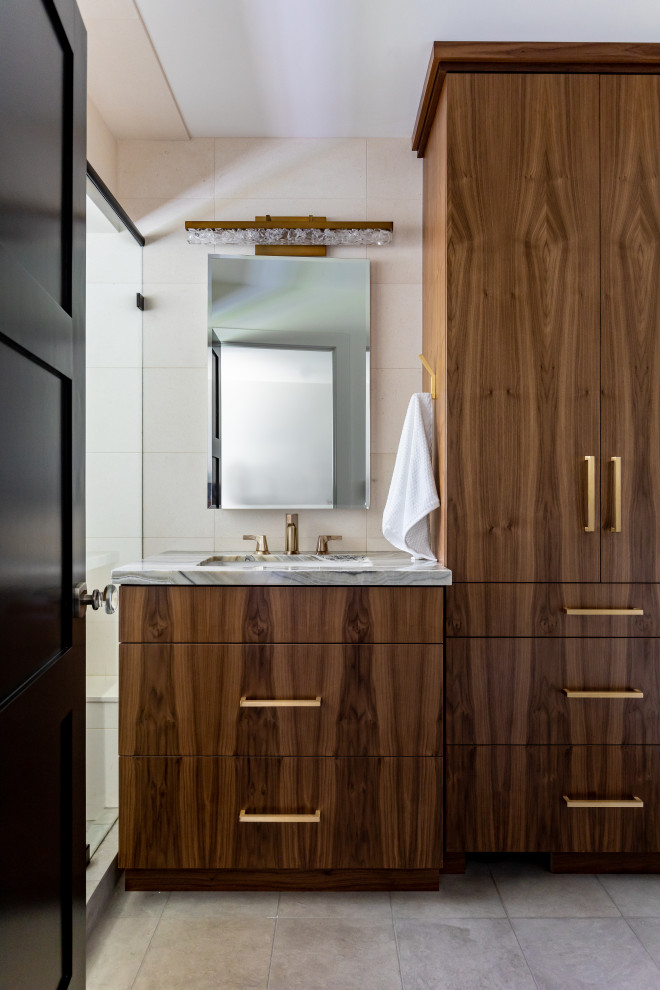 Photo of a small contemporary bathroom in Salt Lake City with flat-panel cabinets, medium wood cabinets, beige tiles, travertine tiles, limestone flooring, a built-in sink, onyx worktops, grey floors, a hinged door, a shower bench and a single sink.