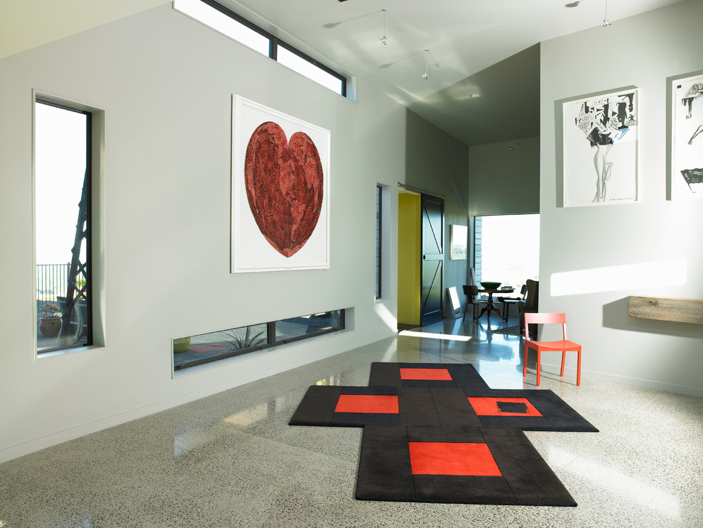 This is an example of a Large contemporary Open Concept living room in Hamilton With Beige Walls, Concrete Floors and a Standard Fireplace.