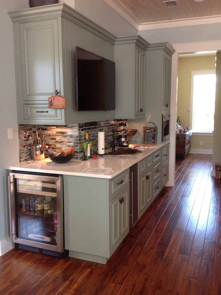 Eat-in kitchen - large transitional u-shaped porcelain tile eat-in kitchen idea in Miami with an undermount sink, flat-panel cabinets, green cabinets, quartz countertops, multicolored backsplash, mosaic tile backsplash, stainless steel appliances and an island